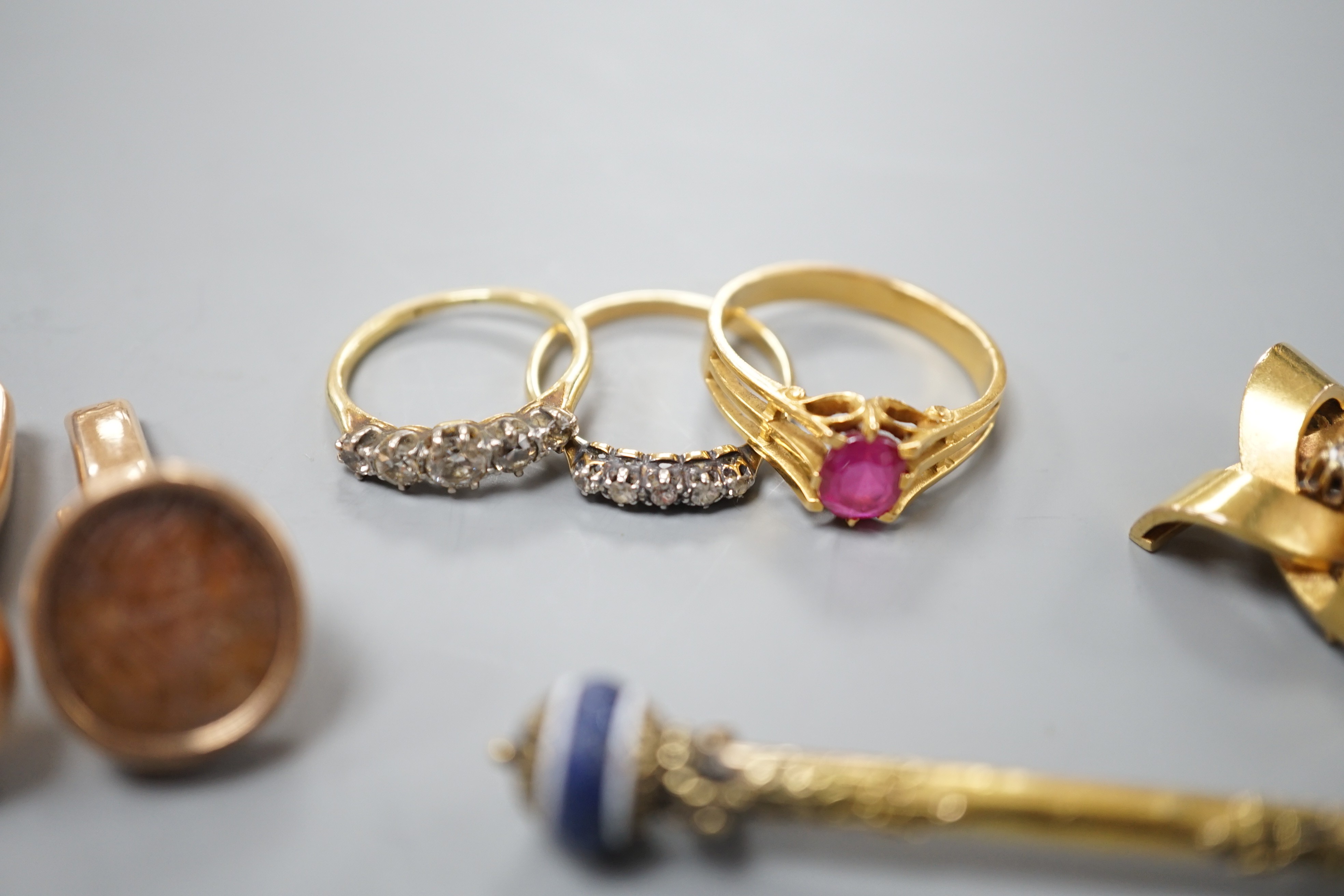 A group of mixed jewellery including two 18ct and diamond half hoop rings, a pair of Middle Eastern yellow metal and talismanic carnelian intaglio cufflinks, a yellow metal and diamond set brooch, a synthetic? ruby set y